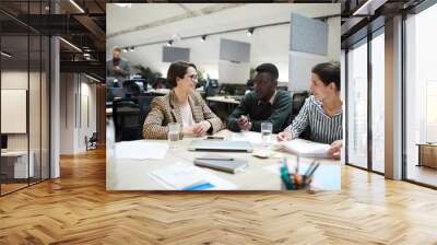 Multi-ethnic group of smiling business people working together in office, copy space Wall mural