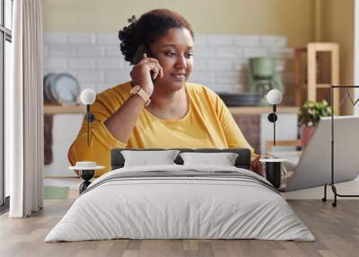 Portrait of black young woman doing business while working from home Wall mural