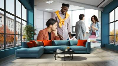 Portrait of diverse business team working in modern office with focus on two contemporary men in foreground, copy space Wall mural