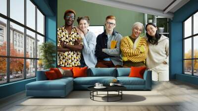 Portrait of diverse creative team in office all looking at camera with cheerful smiles Wall mural