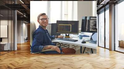 Portrait of IT Programmer Using Computers with Code on Screen Wall mural