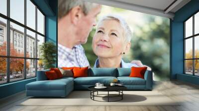 Portrait of loving senior couple embracing and looking at each other focus on elegant woman smiling at husband, copy space Wall mural