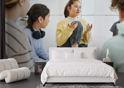 Portrait of teenage girl sharing feelings in support group circle for children Wall mural