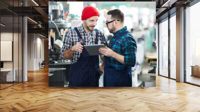 Portrait of two factory workers using digital tablet in workshop Wall mural