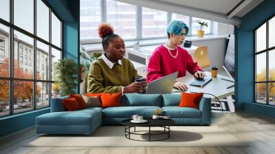 Portrait of two gen Z young people using computers while developing software and writing code in modern office, magenta accent Wall mural