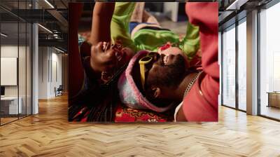 Side view closeup of funky young people lying on floor in circle and holding smartphones Wall mural