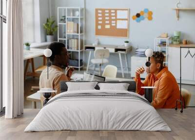 Side view portrait of two black business people working together during meeting in IT development office Wall mural