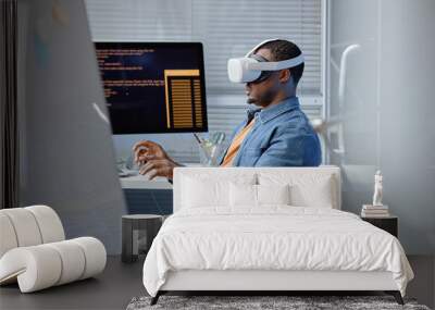 Side view shot of male African American software developer testing VR user experience wearing VR headset in IT company office, copy space Wall mural