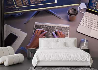 Top view of male hands typing at computer keyboard at workplace in high tech IT office Wall mural