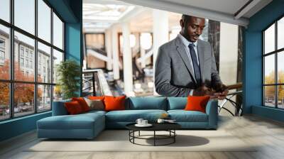 Waist up portrait of African-American businessman standing at balcony and using smartphone in luxurious hotel lobby, copy space Wall mural