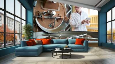 Waist up portrait of modern worker wearing lab coat  working in coffee production manufactory, copy space Wall mural