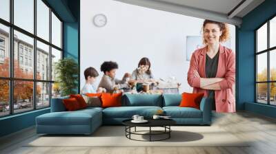 Waist up portrait of smiling female teacher looking at camera with group of children making wooden models during art and craft class in school, copy space Wall mural