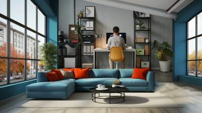 Wide angle back view at man using computer at home office with modern tech interior, copy space Wall mural