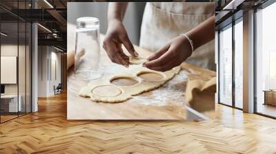 Young black woman baking homemade pastry and cutting cookie shapes Wall mural