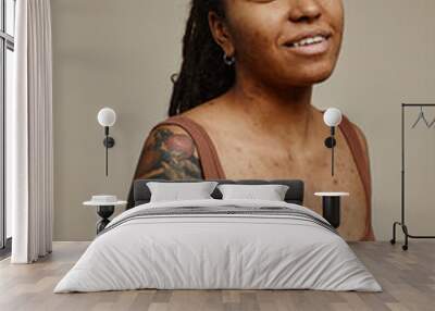 Young black woman looking at camera with tattoos and real skin texture Wall mural