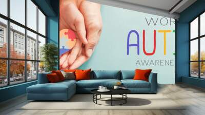 Adult and chiild hands holding jigsaw puzzle heart shape, Autism awareness, Autism spectrum family support concept, World Autism Awareness Day Wall mural