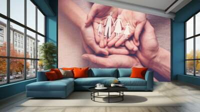 Adult and children hands holding paper family cutout, family home, adoption foster care, homeless charity,family mental health, household budget during inflation Wall mural