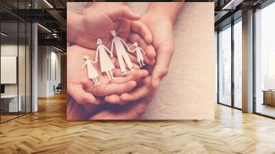 hands holding paper family cutout, family home, adoption foster care, homeless support , mental health, homeschooling , cost of living during  recession concept Wall mural