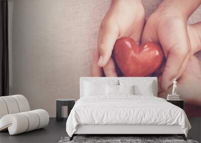 hands holding red heart, heart health, charity volunteer donation, CSR responsibility, world heart day, world health day, family day, adoption foster care home, all lives matter, no to racism concept Wall mural