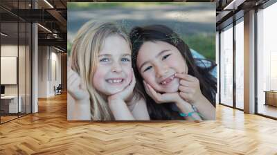 Happy and healthy mixed ethnic young little girls smiling in the park, multiethnic best friends and friendship, all lives matter, no to racism, equality concept Wall mural