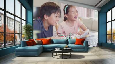 Mixed race young Asian children having fun learning coding together, learning remotely at home, STEM science, homeschooling education, Social distancing, isolation, new normal concept Wall mural