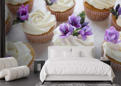 Rose flower frosting vanilla cupcakes with purple edible flowers Wall mural