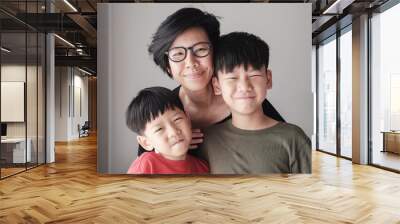 Smiling Mother and sons at home, Happy Asian family portrait Wall mural