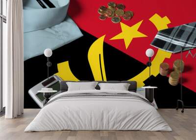 Angola flag on minimal money concept table. Coins and financial objects on flag surface. National economy theme. Wall mural