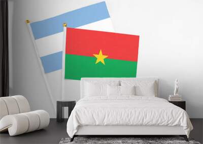 Burkina Faso and Argentina stick flags on white background. High quality fabric, miniature national flag. Peaceful global concept.White floor for copy space. Wall mural