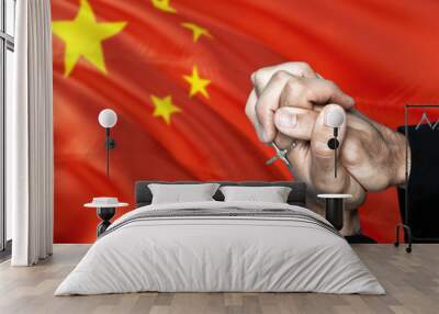 China flag and praying patriot man with crossed hands. Holding cross, hoping and wishing. Wall mural