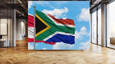 Greenland and South Africa flag waving in the wind against white cloudy blue sky together. Diplomacy concept, international relations. Wall mural