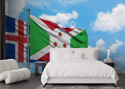 Iceland and Burundi flag waving in the wind against white cloudy blue sky together. Diplomacy concept, international relations. Wall mural