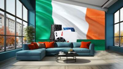 Ireland casino theme. Two ace in poker game, cards and black chips on green table with national flag background. Gambling and betting. Wall mural