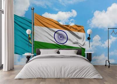 Kazakhstan and India flag waving in the wind against white cloudy blue sky together. Diplomacy concept, international relations. Wall mural