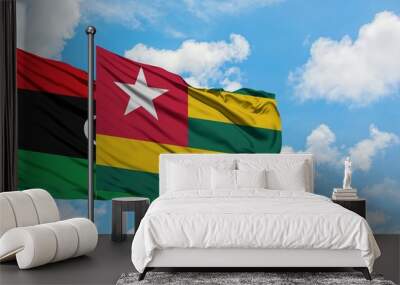 Libya and Togo flag waving in the wind against white cloudy blue sky together. Diplomacy concept, international relations. Wall mural