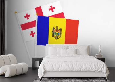 Moldova and Georgia stick flags on white background. High quality fabric, miniature national flag. Peaceful global concept.White floor for copy space. Wall mural