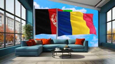 Romania and Afghanistan national flag waving in the wind on a deep blue sky together. High quality fabric. International relations concept. Wall mural