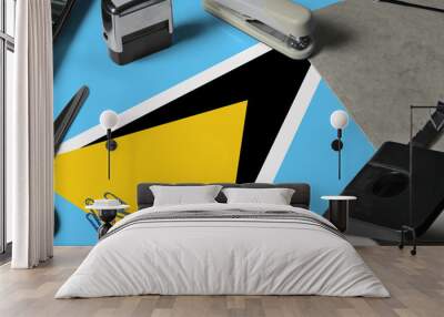 Saint Lucia flag with office clerk workplace background. National stationary concept with office tools. Wall mural