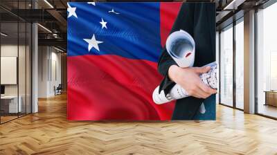 Samoan Architect woman holding blueprint against Samoa waving flag background. Construction and architecture concept. Wall mural