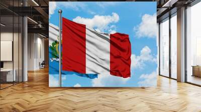 San Marino and Peru flag waving in the wind against white cloudy blue sky together. Diplomacy concept, international relations. Wall mural