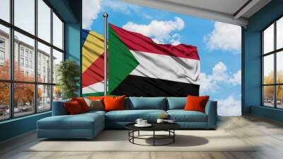 Seychelles and Sudan flag waving in the wind against white cloudy blue sky together. Diplomacy concept, international relations. Wall mural