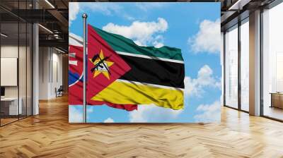 Slovakia and Mozambique flag waving in the wind against white cloudy blue sky together. Diplomacy concept, international relations. Wall mural