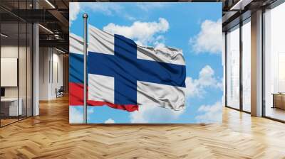 Slovenia and Finland flag waving in the wind against white cloudy blue sky together. Diplomacy concept, international relations. Wall mural