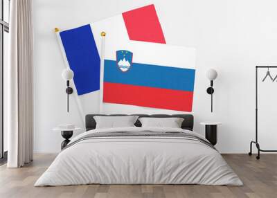 Slovenia and France stick flags on white background. High quality fabric, miniature national flag. Peaceful global concept.White floor for copy space. Wall mural