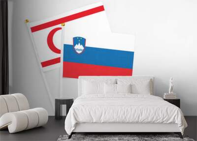 Slovenia and Northern Cyprus stick flags on white background. High quality fabric, miniature national flag. Peaceful global concept.White floor for copy space. Wall mural