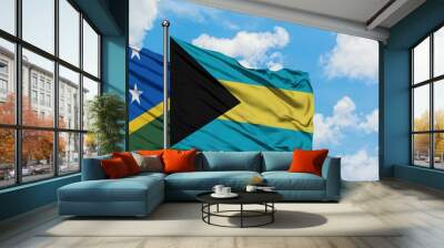 Solomon Islands and Bahamas flag waving in the wind against white cloudy blue sky together. Diplomacy concept, international relations. Wall mural