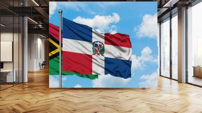 Vanuatu and Dominican Republic flag waving in the wind against white cloudy blue sky together. Diplomacy concept, international relations. Wall mural