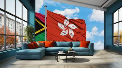 Vanuatu and Hong Kong flag waving in the wind against white cloudy blue sky together. Diplomacy concept, international relations. Wall mural