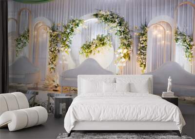 minimalist white wedding decoration with green paper flowers, white sofa chair and decorated with lights, Indonesian wedding, corner view Wall mural