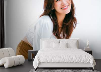 Portrait of smiling Asian woman standing on white background, photogenic mature woman Wall mural